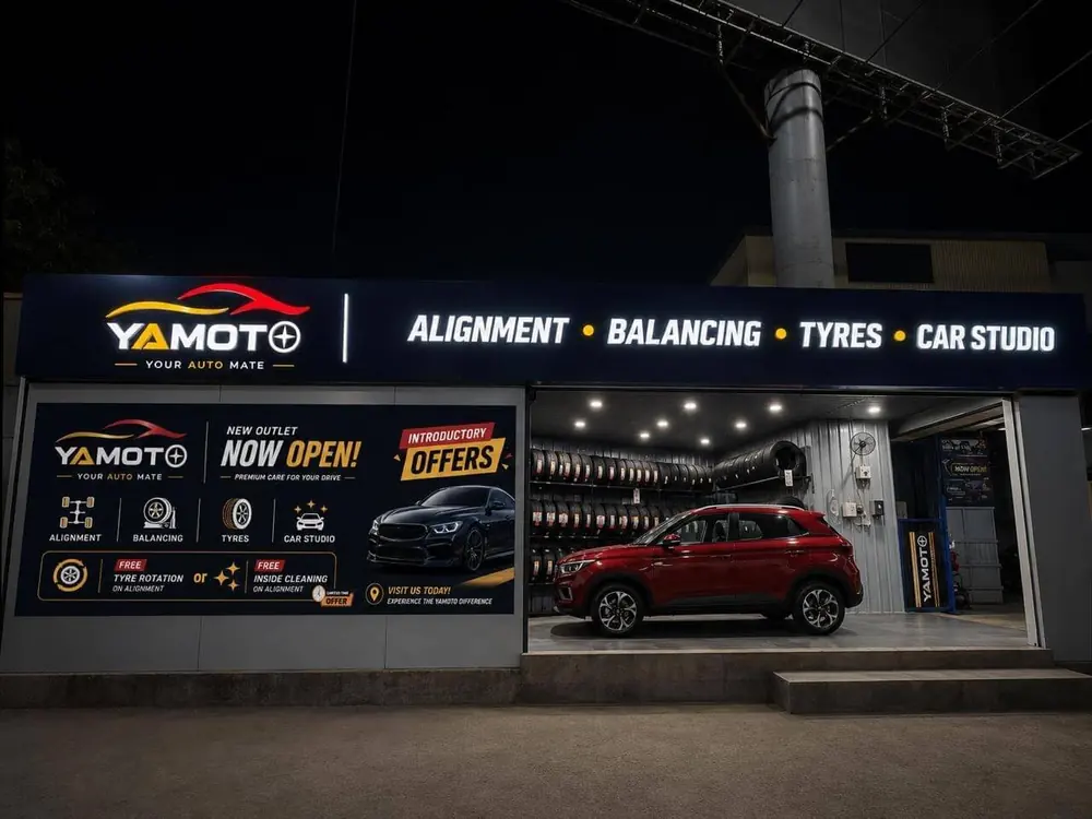 Yamoto tyre shop illuminated storefront with Alignment Balancing Tyres signboard at night, Narsingi