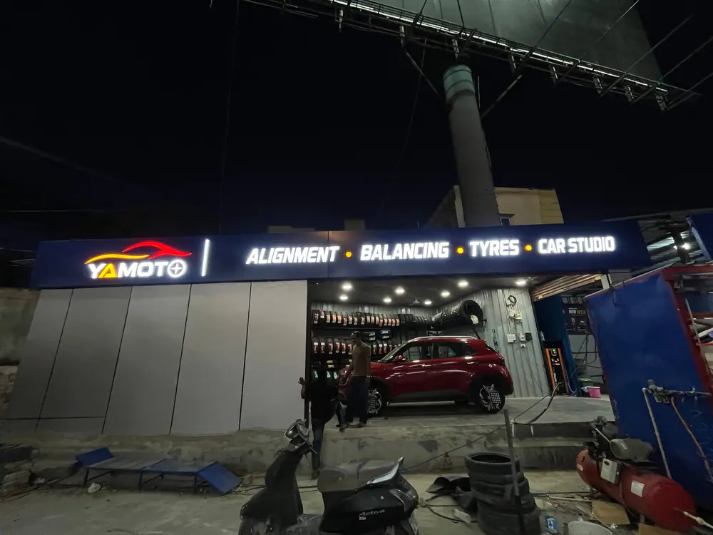 Yamoto workshop exterior at night with car in bay, Narsingi Hyderabad